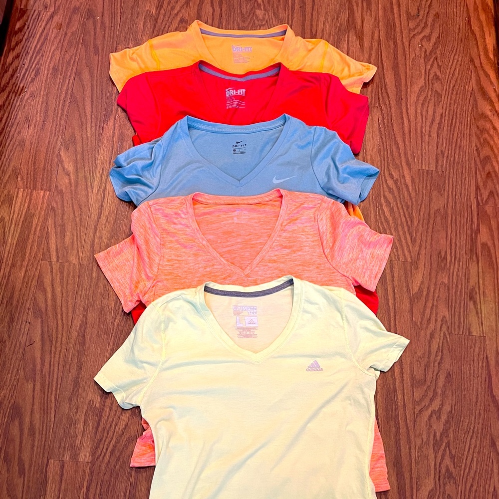 4 Nike and 1 adidas women’s large workout shirts